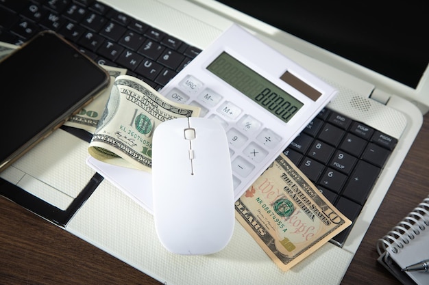 Computer mouse and money on computer keyboard