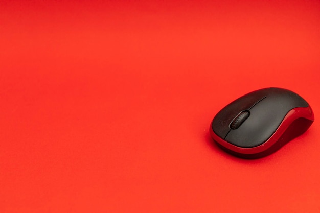 Computer mouse on red background