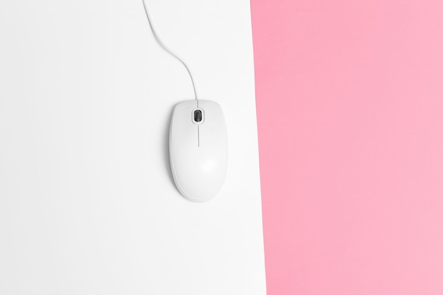 Computer mouse with a cord over a paper background
