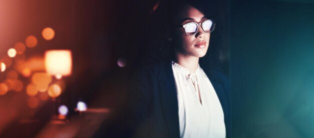 computer night and programmer with a black woman developer working late in her office for coding software cybersecurity and programming with a female coder at work for overtime on a project