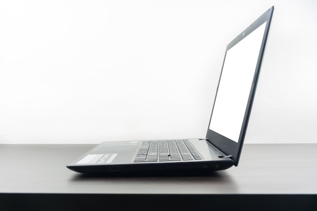 Computer notebook blank screen on wood table