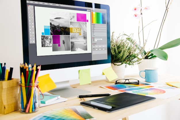 Photo computer and office supplies on desk