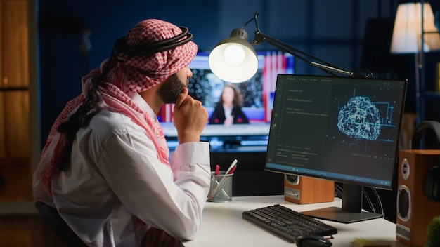 Computer operator updating artificial intelligence neural networks writing complex binary code scripts Outsourcing arabic freelancer in personal office uses digital device programming to upgrade AI