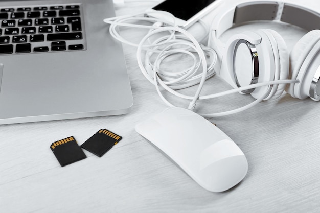 Photo computer peripherals and laptop accessories on white wooden background