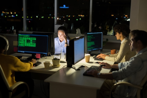 Computer Programmers Coding at Night