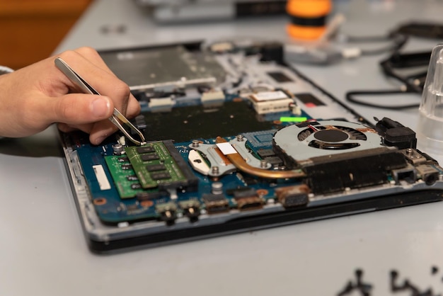 Computer repair technician repairing a laptop