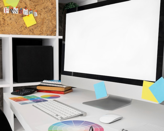 Computer screen on office desk surface with keyboard