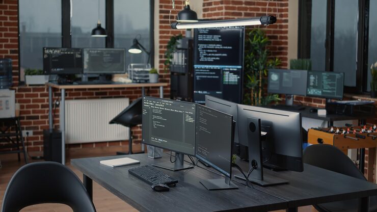Photo computer screens running programming code in empty software it agency office and computers parsing data algorithms in background. neural network servers cloud computing in data room.