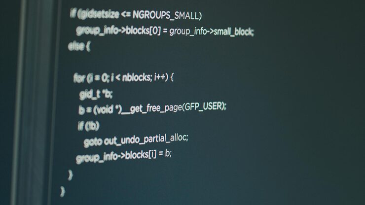 Photo computer of system engineer showing source code and big data in it development agency. concept of software developer displaying programming language of database functions script. close up.