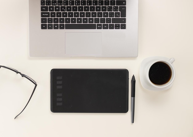 Computer on the table with digital tablet to edit with coffee