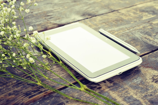 Computer tablet on a wooden background