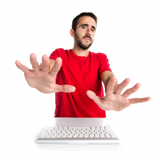 Computer technician working with his keyboard making stop sign