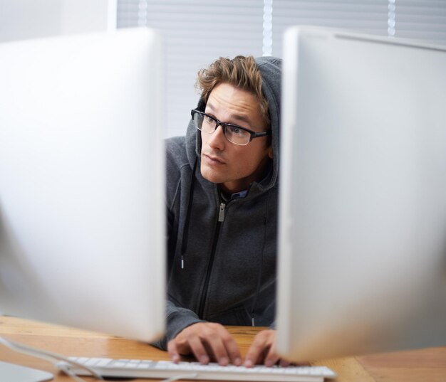 computer typing and man hacking online database system or software via password phishing fraud or virus ransomware developer cybersecurity crime or hacker coding malware for corporate espionage
