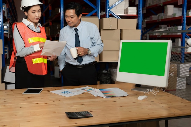 Computer with green screen display in warehouse storage room