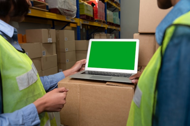 Photo computer with green screen display in warehouse storage room