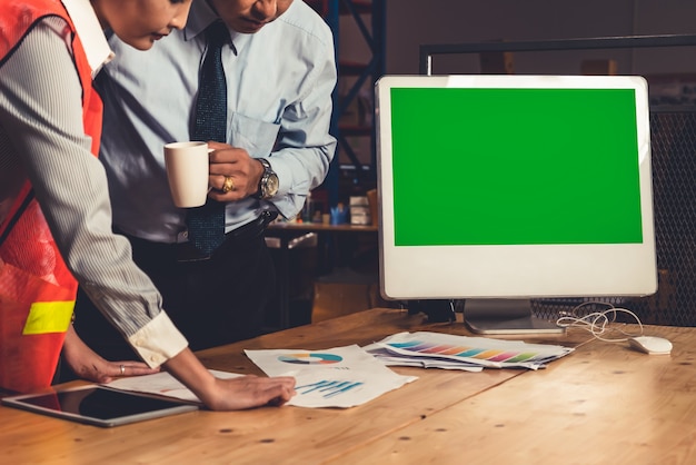 Photo computer with green screen in warehouse