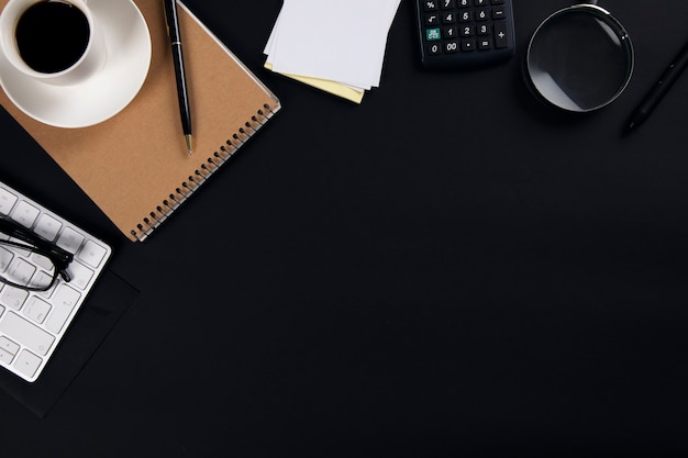 Computer with notepad and coffee with calculator on office table