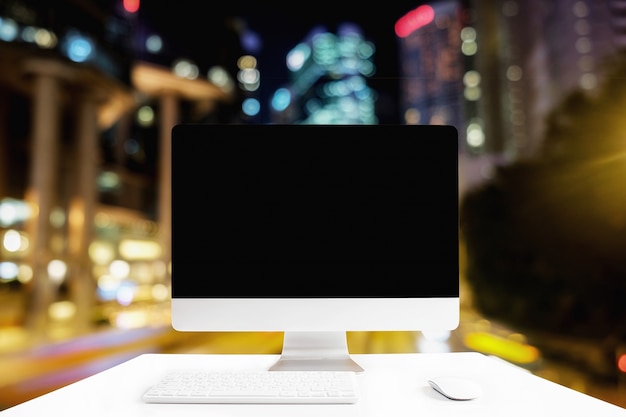 Photo computer with white screen on table with blur background. technology concept.