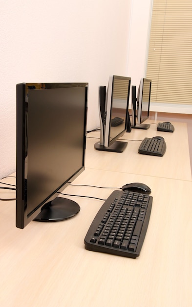 Computers on tables in room