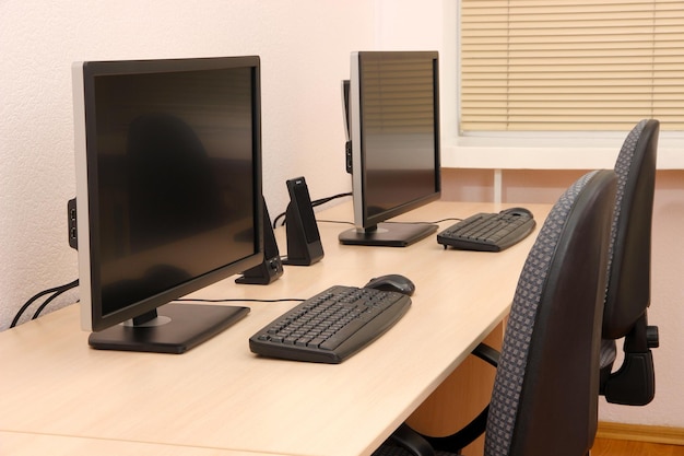 Computers on tables in room