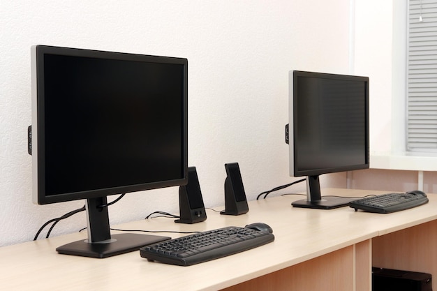 Computers on tables in room