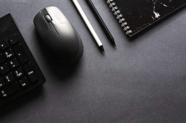 Computertoetsenbord en muis op een zwarte achtergrond. Ruimte kopiëren. Platte bovenaanzicht.