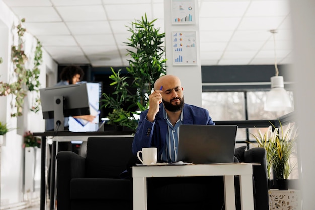 Concentrated arab man thinking about project financial report