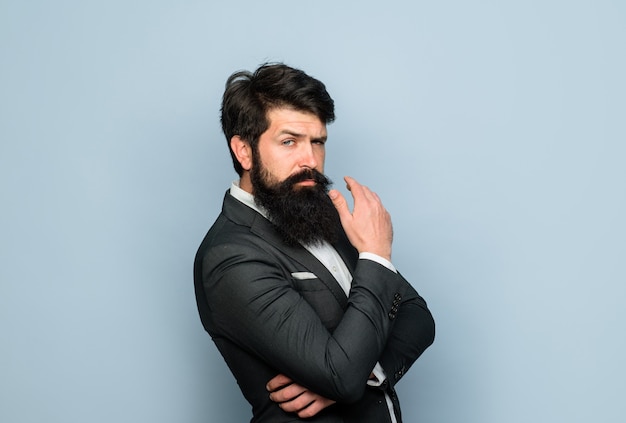 Concentrated bearded man thinking about something thoughtful expression thinking businessman pensive