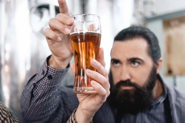 Concentrated Bearded Worker Checks Ale Color.