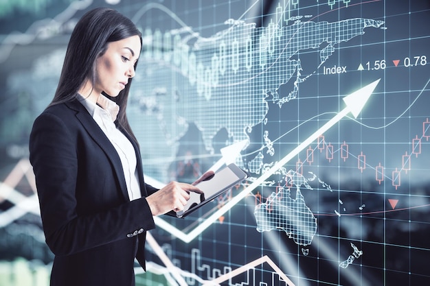 Concentrated Businesswoman Using Digital Tablet On Virtual Wall Background With Stock Market Changes Numbers Forex Dynamics Map And Glowing Raising Arrows World Trade Market Concept