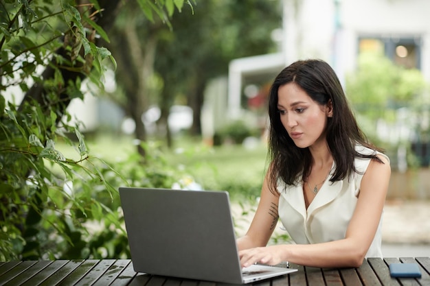 Concentrated Businesswoman Working on Laptop