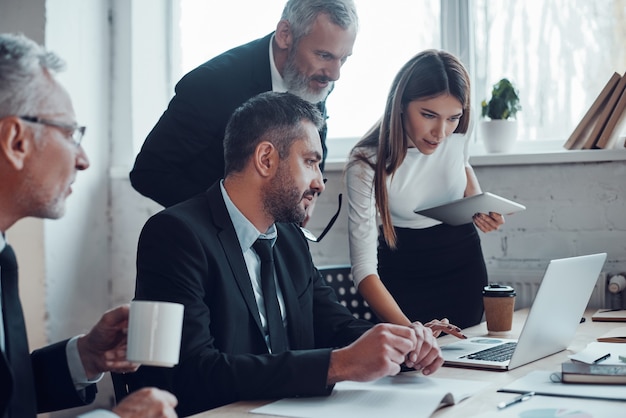 Concentrated colleagues planning next business step while working together in the modern office