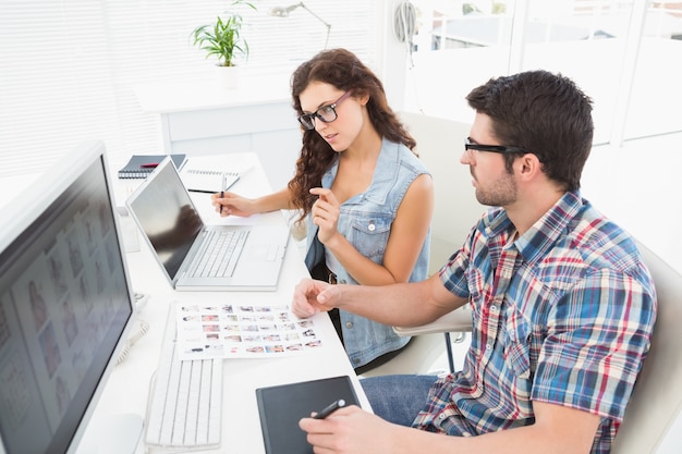 Concentrated coworkers using laptop and digitizer 