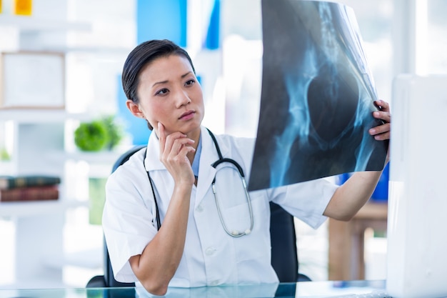 Concentrated doctor analyzing X-rays