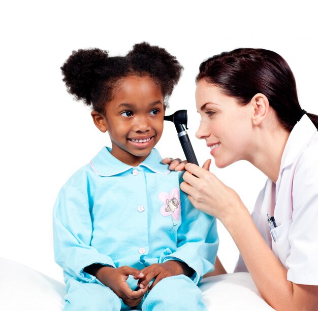 Concentrated doctor checking her patient's ears 