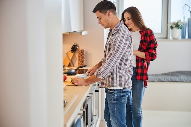 Concentrated husband making a salad for his wife