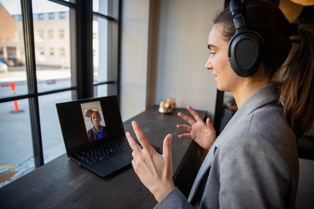 Photo concentrated millennial businesswoman during working video call