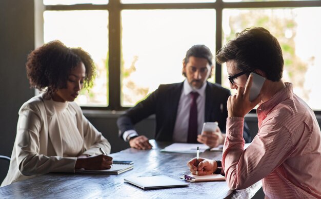 Photo concentrated multicultural colleagues gathering in boardroom brainstorming