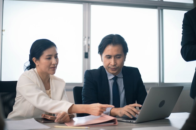 Concentrated multiethnic coworker busy using laptop brainstorm sharing thoughts at office meeting