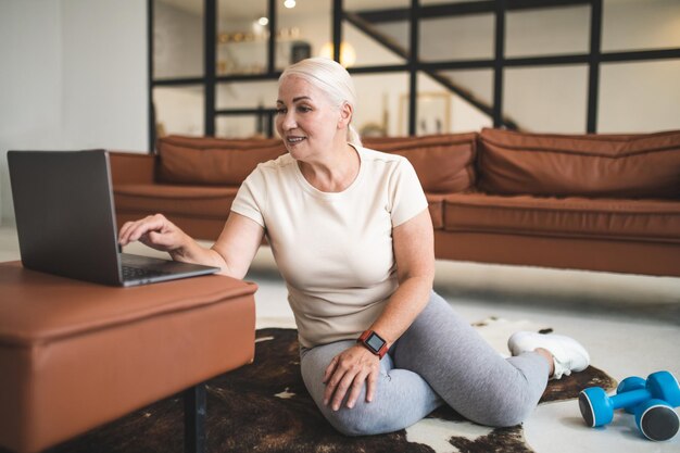 Concentrated pleased fit woman preparing for the home workout