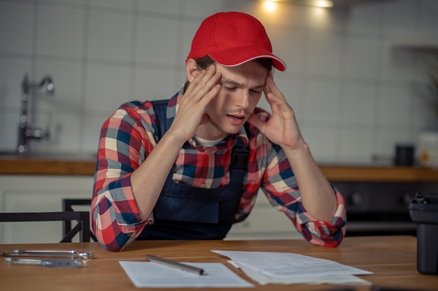 Concentrated serviceman perusing technical documentation before work