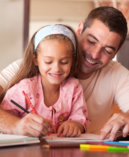 Concentrated smiling girl painting 