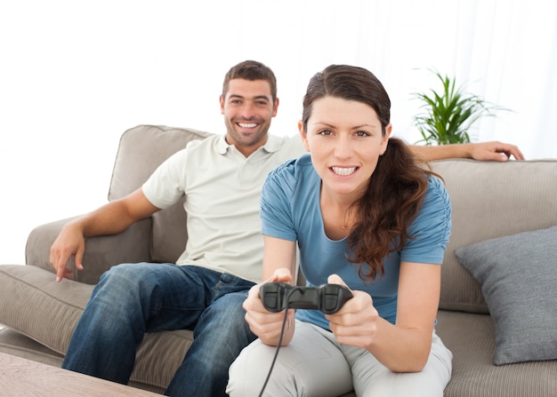 Concentrated woman playing video game with her boyfriend 