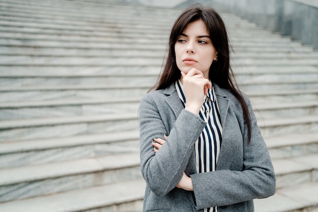 Concentrated woman thinking outdoors