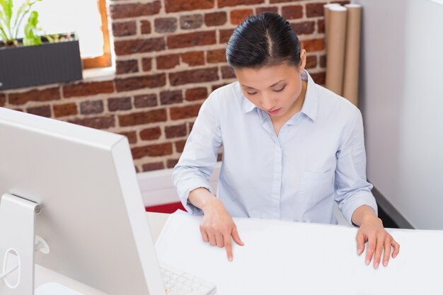 Concentrated woman working at desk