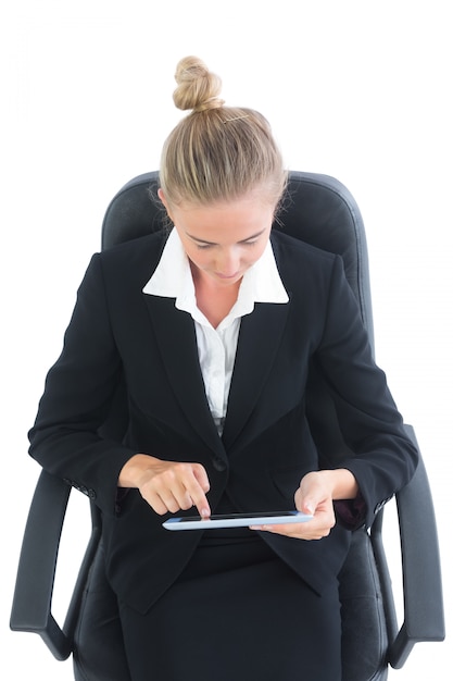 Concentrated young businesswoman using her tablet