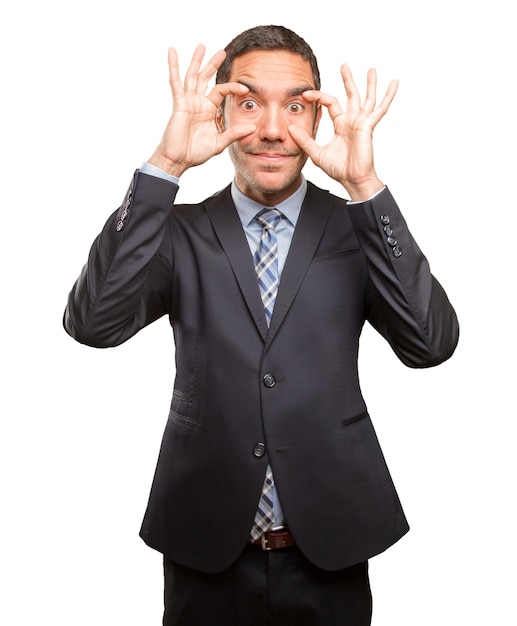 Concentrated young man doing an observation gesture