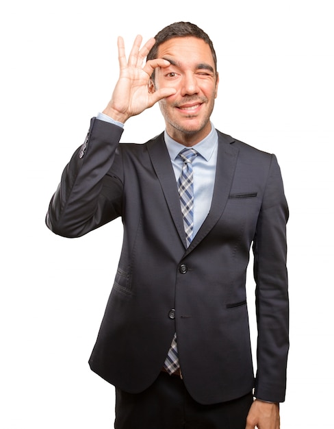 Concentrated young man doing an observation gesture