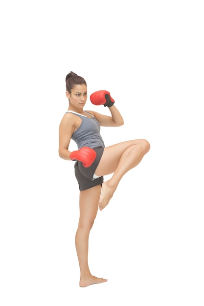 Concentrating sporty brunette kick boxing