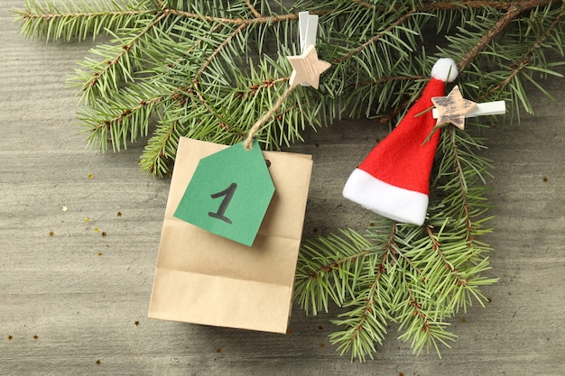 Concept of Advent calendar gift on gray wooden background.